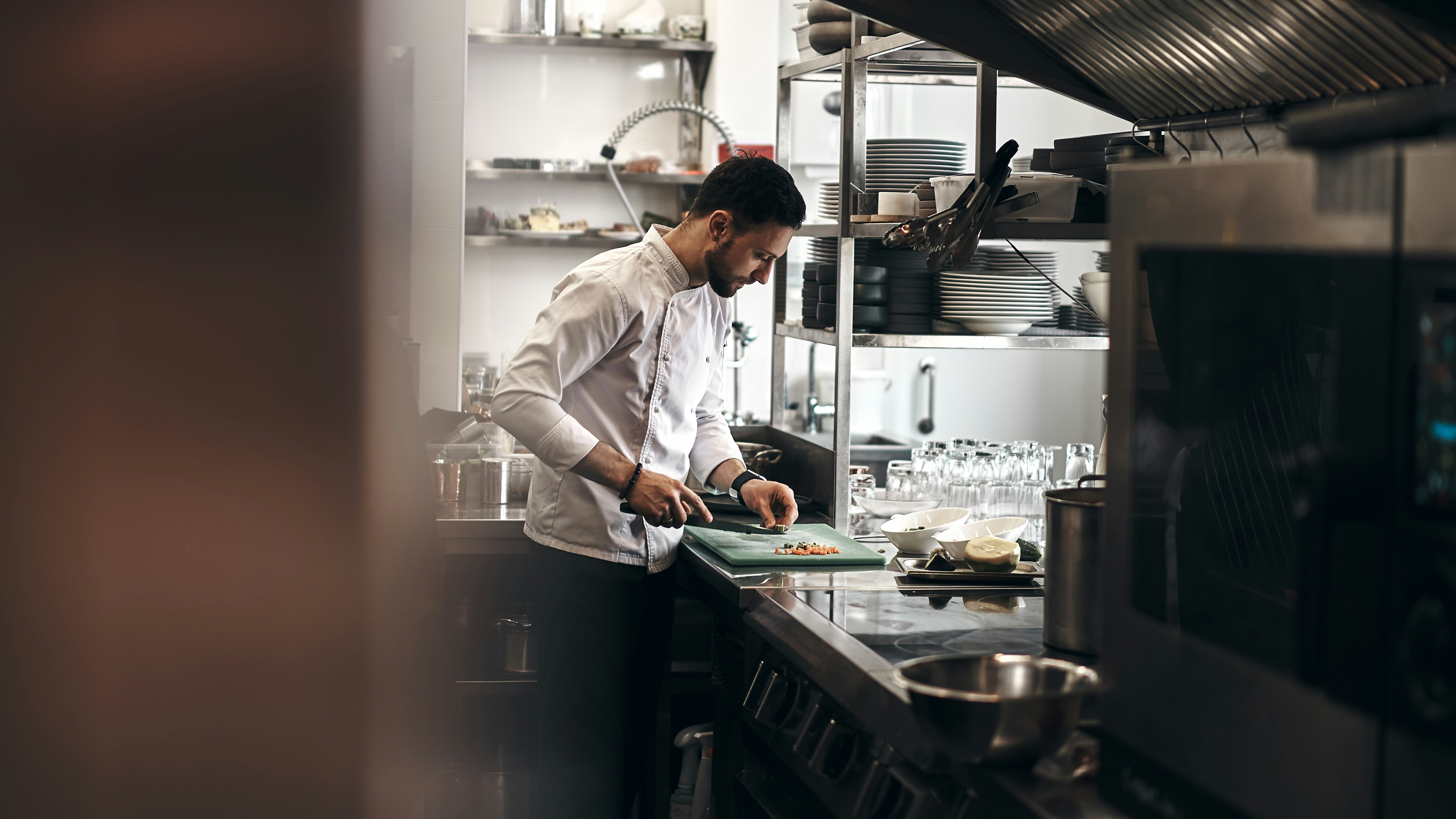 Chef preparing ingredients in a commercial kitchen for accurate, consistent restaurant orders.